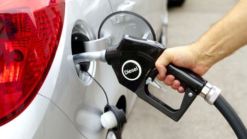 Man filling car with diesel pump