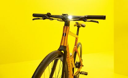 MCM E-bike with copper frame against yellow background