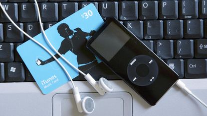 An Apple Nano and ITunes music card on a computer keyboard 07 May 2007, in Miami, Florida. Apple Chief Executive Steve Jobs has opened the door to higher music download prices as a result of 