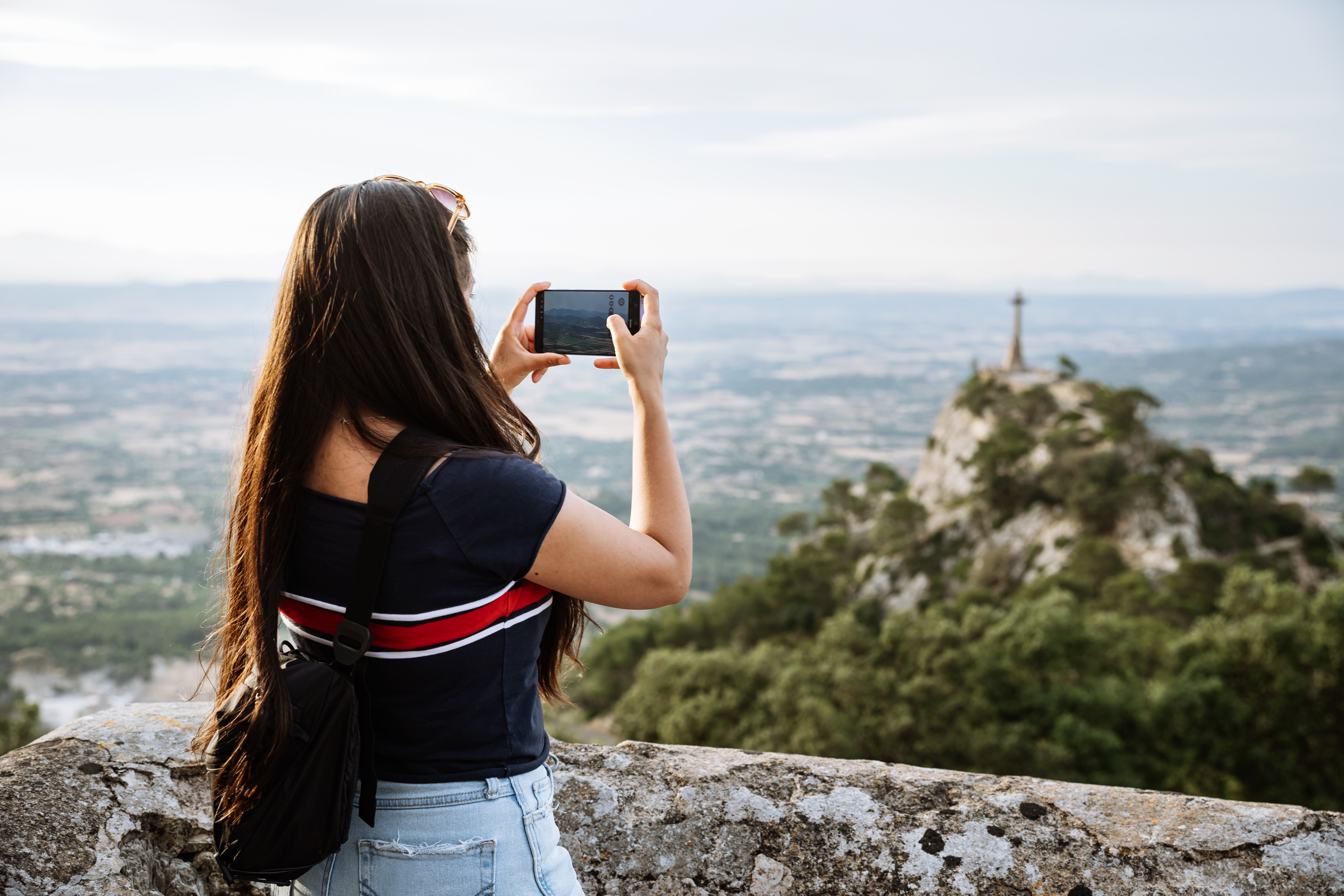 A photographer uses the Samsung Galaxy S26 Ultra camera to take a photo of a landscape