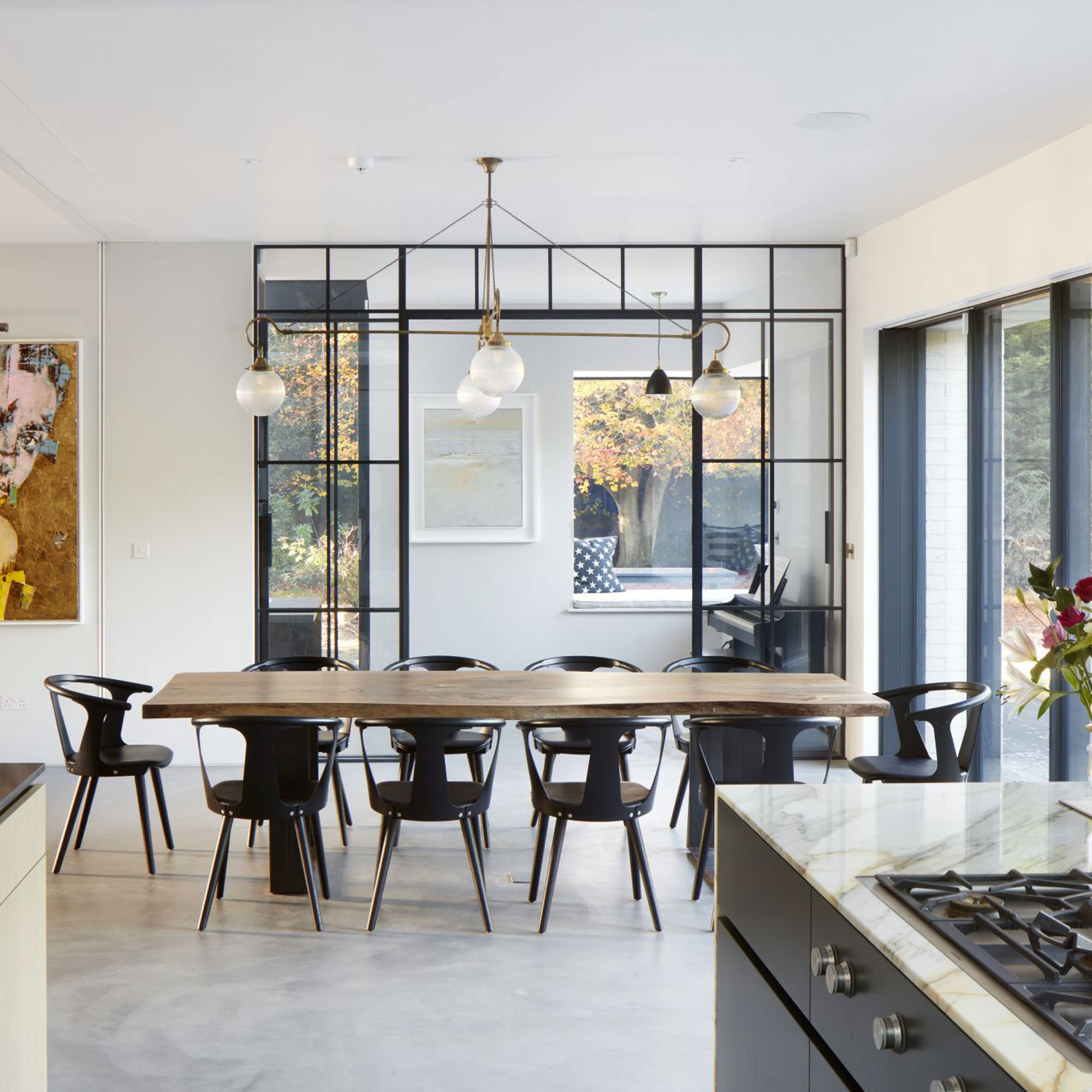 modern kitchen diner extension with poured concrete floor and black framed glass internal doors