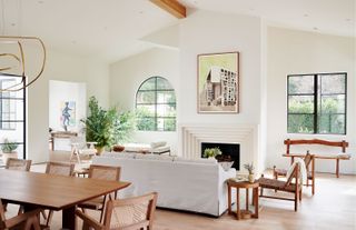 living room with white walls steel windows and pale wood dining table