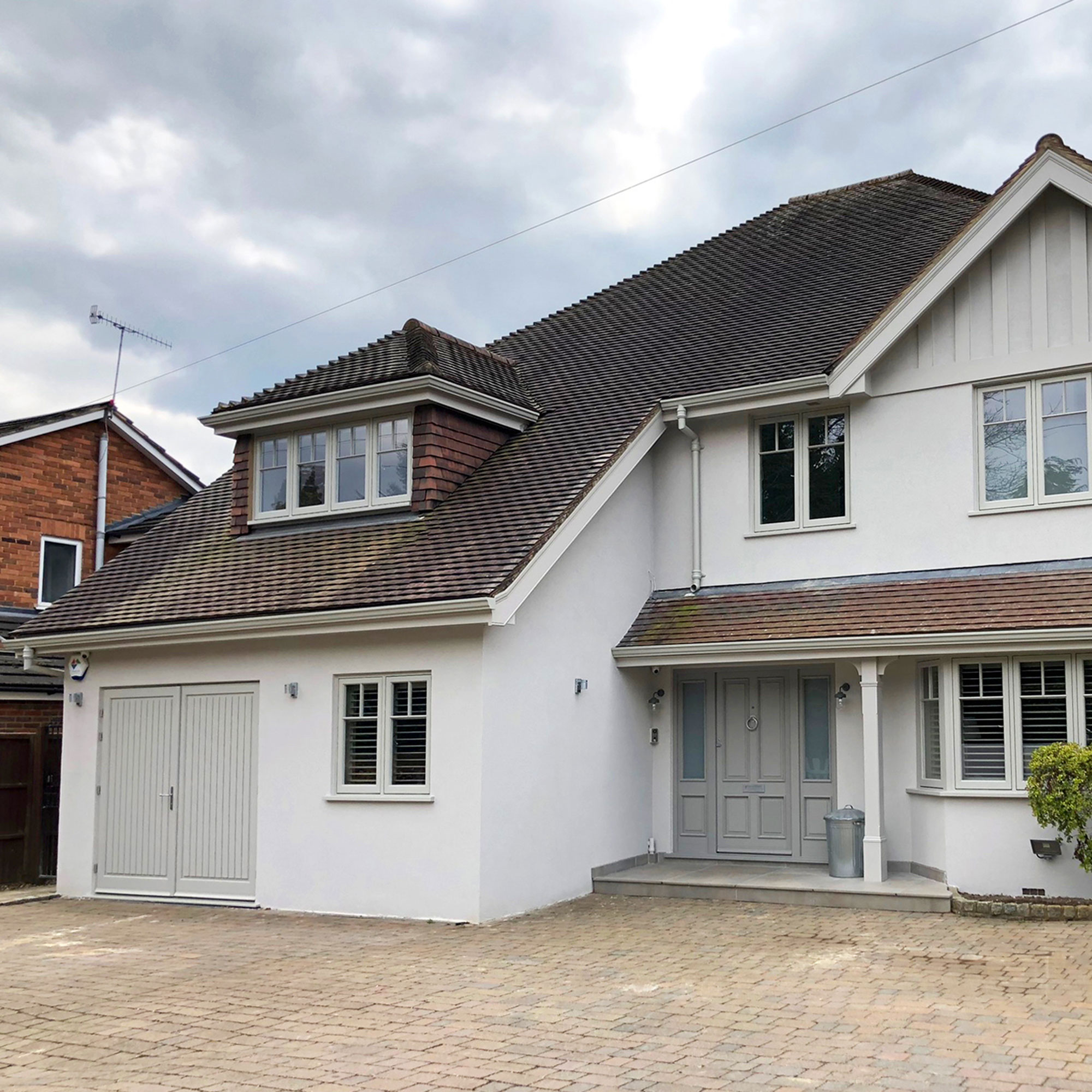 white rendered house with partial garage conversion