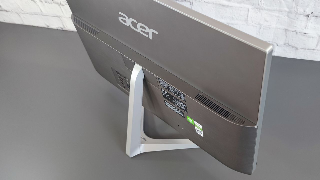 A photograph of the rear of the Acer Aspire C24 on a desk
