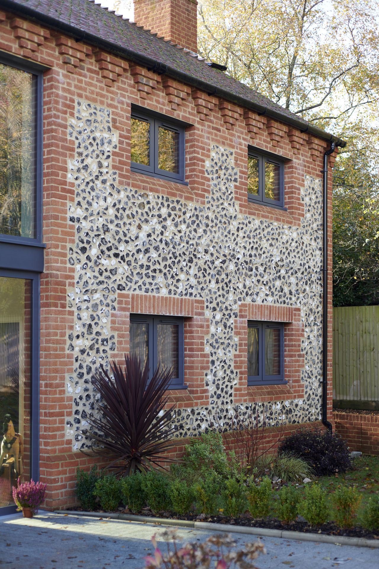 Alan used knapped flint as a decorative finish on the front and back of the house.