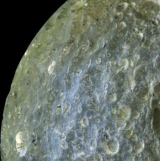 This false-color view of Saturn's moon Mimas from NASA's Cassini spacecraft highlights terrain-dependent color differences and shows dark streaks running down the sides of some of the craters on the region of the moon that leads in its orbit around Saturn