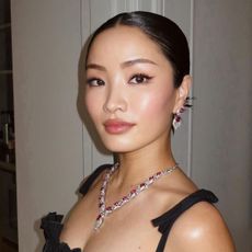 Anna Sawai with a slicked-back hairstyle