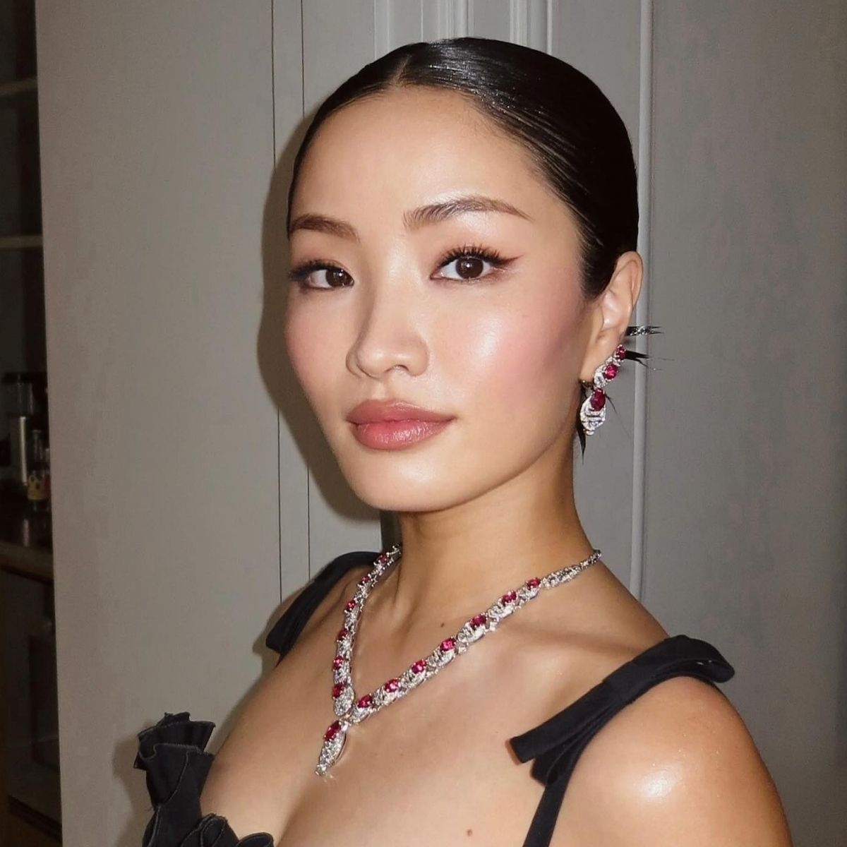 Anna Sawai with a slicked-back hairstyle