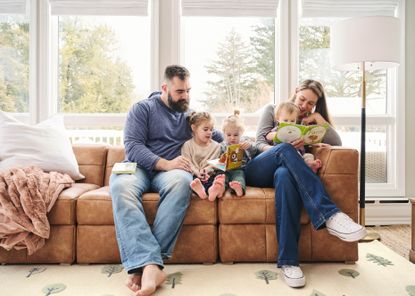 the kelce family reads on a brown leather couch
