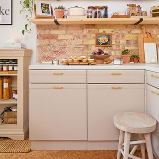 neutral kitchen cabinet with brick wall and shelf