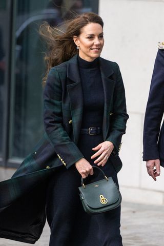 Catherine, Princess of Wales has a green handbag during their visit to Royal Liverpool University Hospital on January 13, 2023 in Liverpool, England.