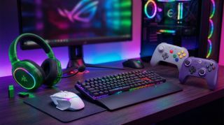 Gaming peripherals on a desk in front of a gaming pc