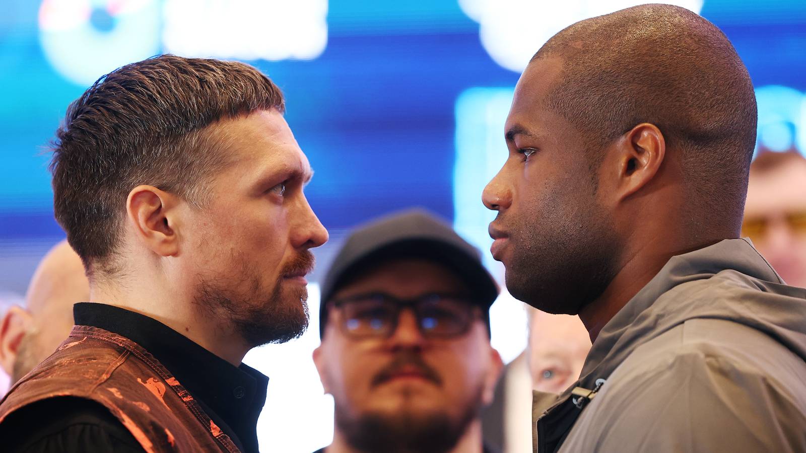 Oleksandr Usyk and Daniel Dubois facing each other at a press conference before their 2025 fight.