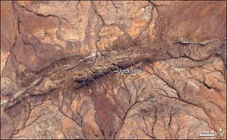 Western Australia’s Jack Hills appear as little more than a charcoal-tinged ridgeline in this image captured by the Landsat satellite July 27, 1999.