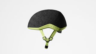 A grey and green commuter helmet from the left side