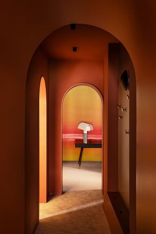 A corridor drenched in orange and yellow tones