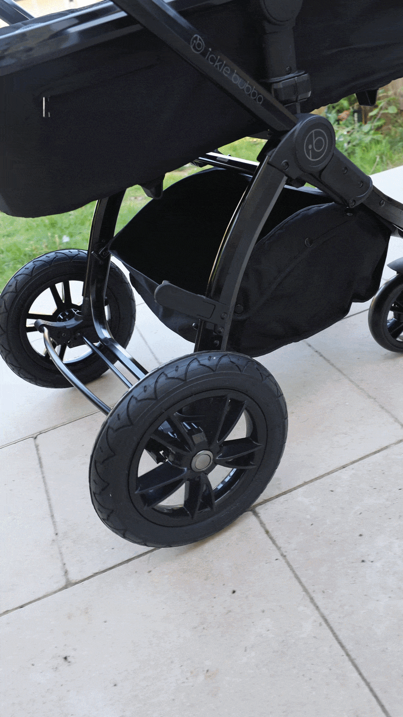 The Ickle Bubba Stomp Luxe Pram being pushed on a patio