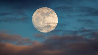 Full Moon, Buck Moon; This is a photo of a moon at over 98% full. The image was taken one day prior to the supermoon, or a moon that appears larger due to being the closest to earth in its elliptic orbit.