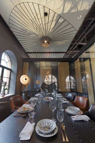 Srips of rice paper artfully dangle atop the brass bar