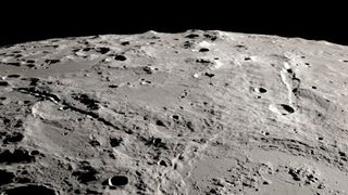 a rough and cratered landscape high above the moon.