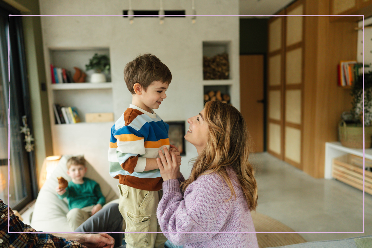 Portrait of a beautiful cheerful family with two young children, spending quality time together in their home