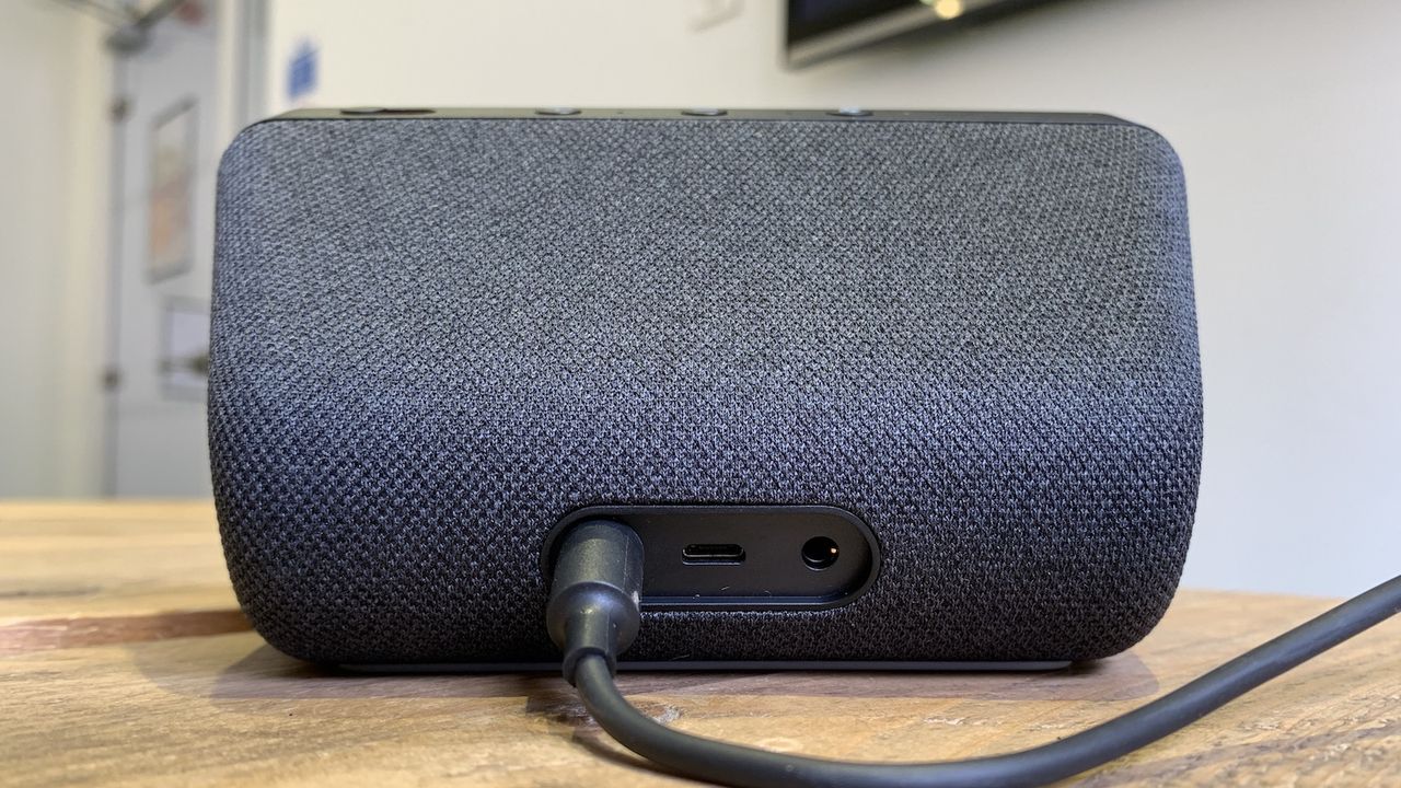 The back of a black Amazon Echo Show 5 smart speaker. You can see a couple of ports and where the power cable is attached.