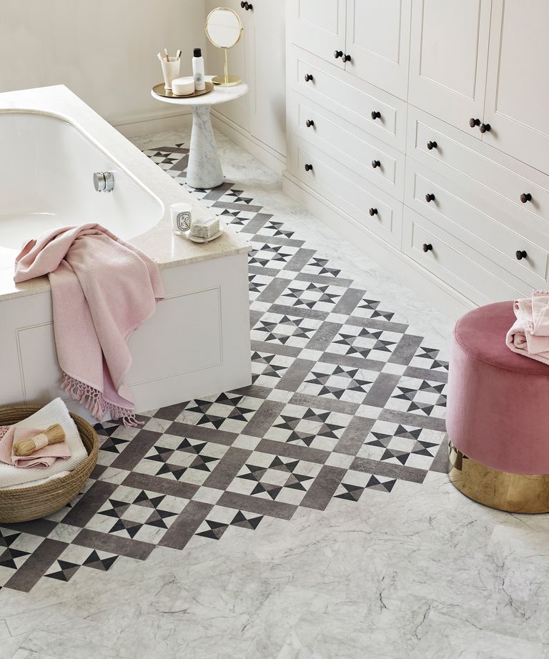 Gray bathroom tile ideas featuring a patterned gray Amtico floor with pink accessories.