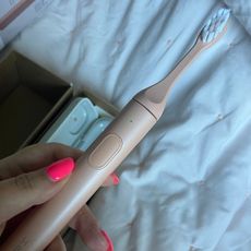 Suri toothbrush review: amelia holding the suri 2.0 toothbrush