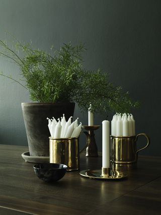 Candles in brass mugs