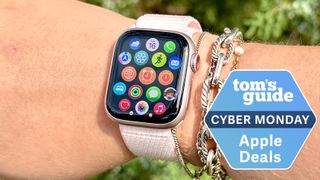 Person wearing the Apple Watch Series 9 outside with the Tom's Guide Cyber Monday deals badge