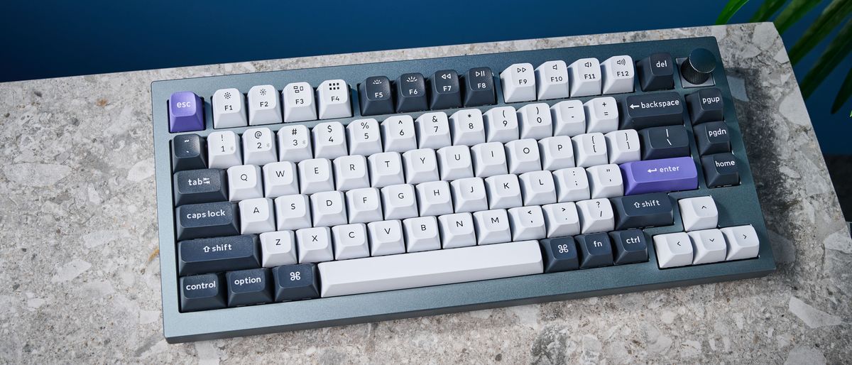 A photo of the Keychron Q1 Pro in gray aluminum with white, black and purple keycaps.