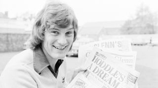 English soccer player Glenn Hoddle of Tottenham Hotspur FC holding newspapers celebrating his outstanding performance with his team, London, UK, 5th December 1979. (Photo by Mike Lawn/Evening Standard/Hulton Archive/Getty Images)