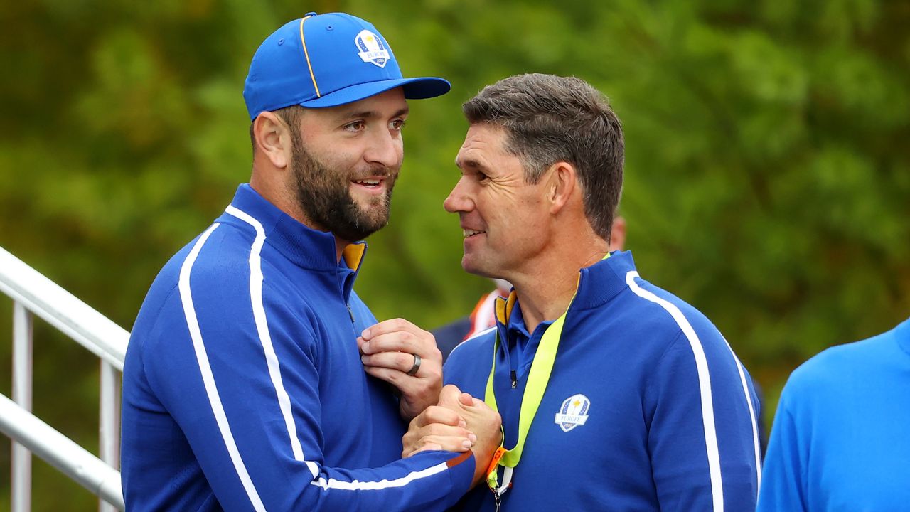 Jon Rahm of Spain and team Europe (L) and captain Padraig Harrington of Ireland and team Europe meet prior to the 43rd Ryder Cup.