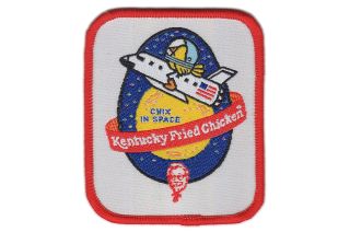 The original "Chix in Space" mission patch produced by Kentucky Fried Chicken for the experiment's 1986 launch.