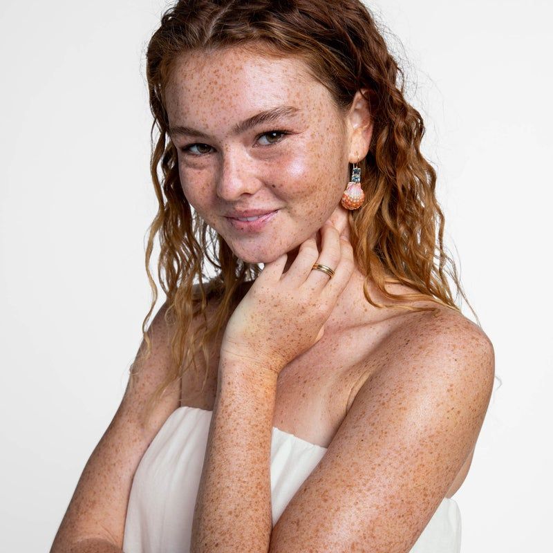 woman smiling and wearing white cover-up