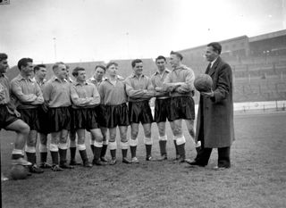 England team manager Walter Winterbottom (1913 - 2002) giving a team talk during a training session at Stamford Bridge, London.