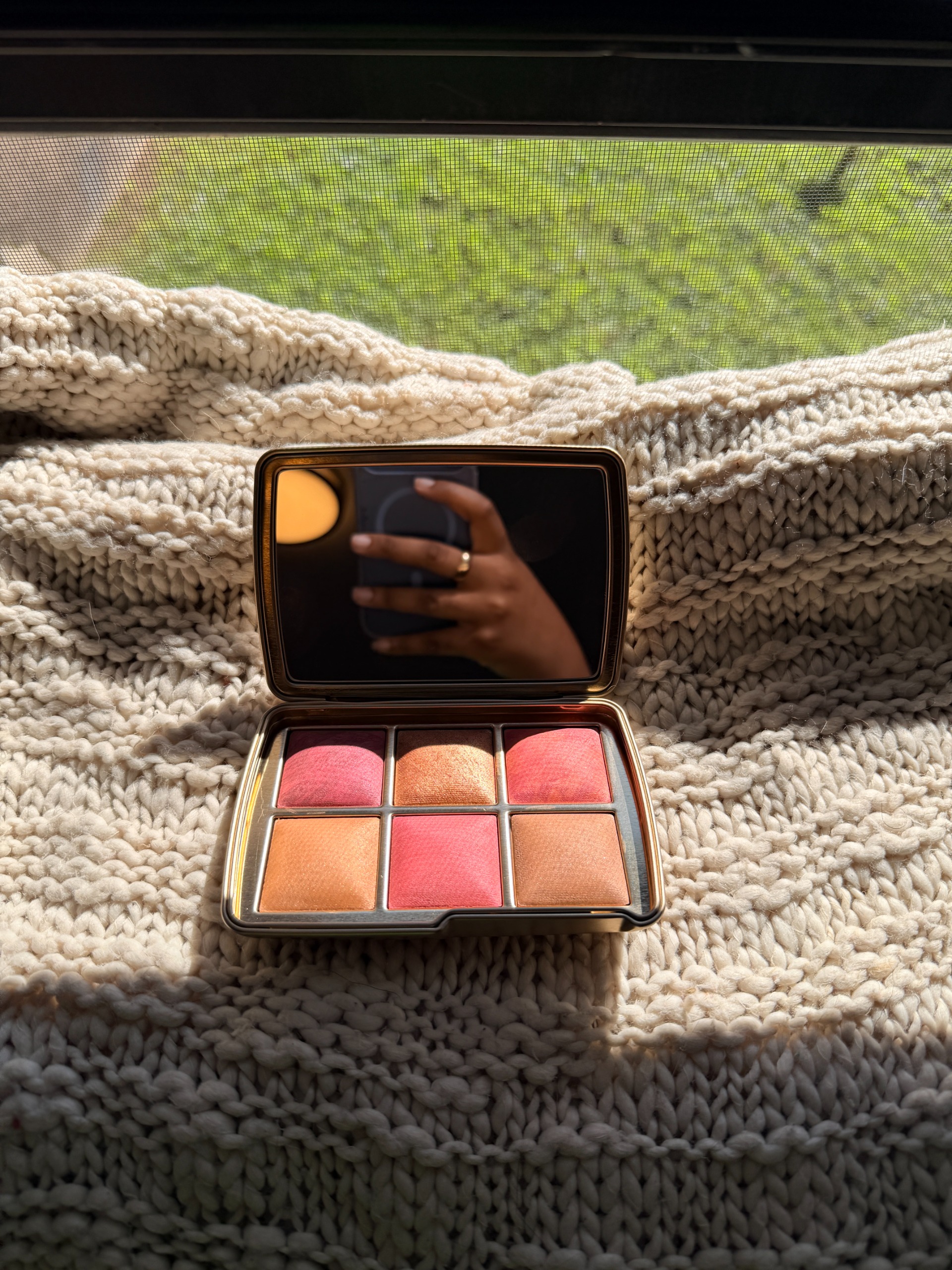 Ariel Wilson testing the Luck Palette outdoors on a blanket