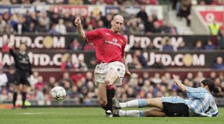 14 Apr 2001: Jaap Stam of Manchester United is challenged by Youssef Chippo of Coventry City during the FA Carling Premiership match at Old Trafford in Manchester, England. United won 4-2. \ Mandatory Credit: Clive Brunskill /Allsport