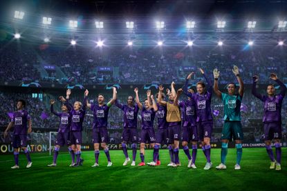 A team wearing purple kits celebrate winning in Football Manager 2023