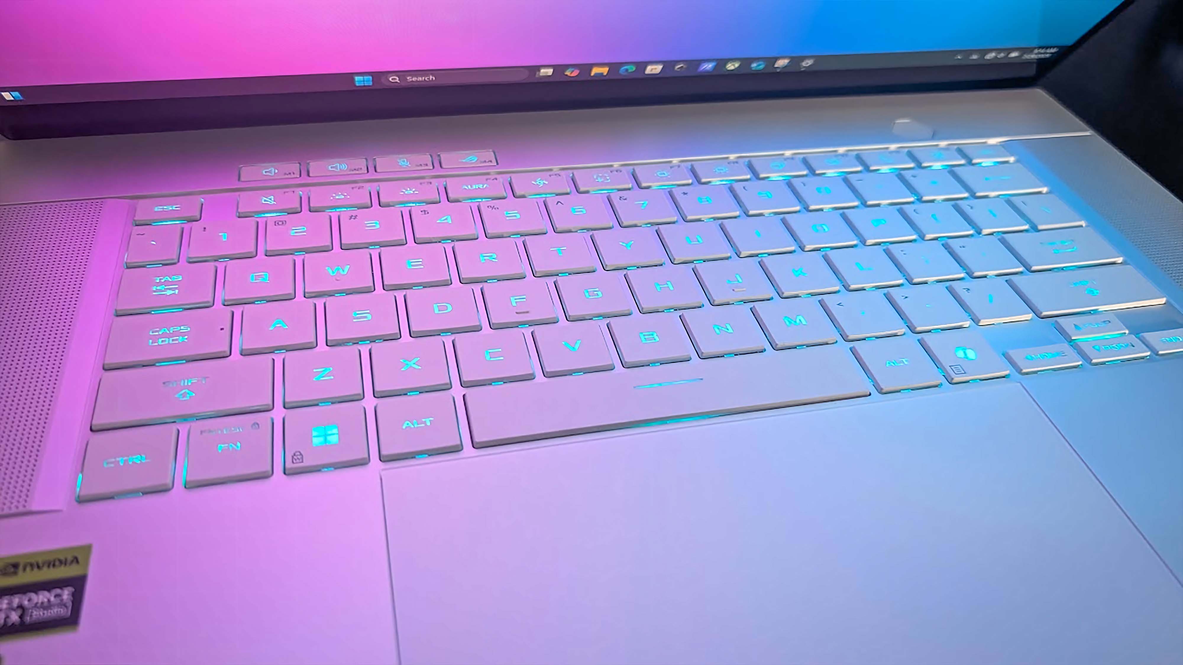 Closeup of the blue backlit keyboard on ASUS ROG Zephyrus G16 (GU605C, 2025).