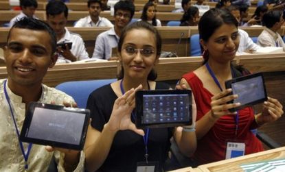 Students display Aakash, the $35 tablet that developers hope will help India's poor and middle class cross the digital divide.