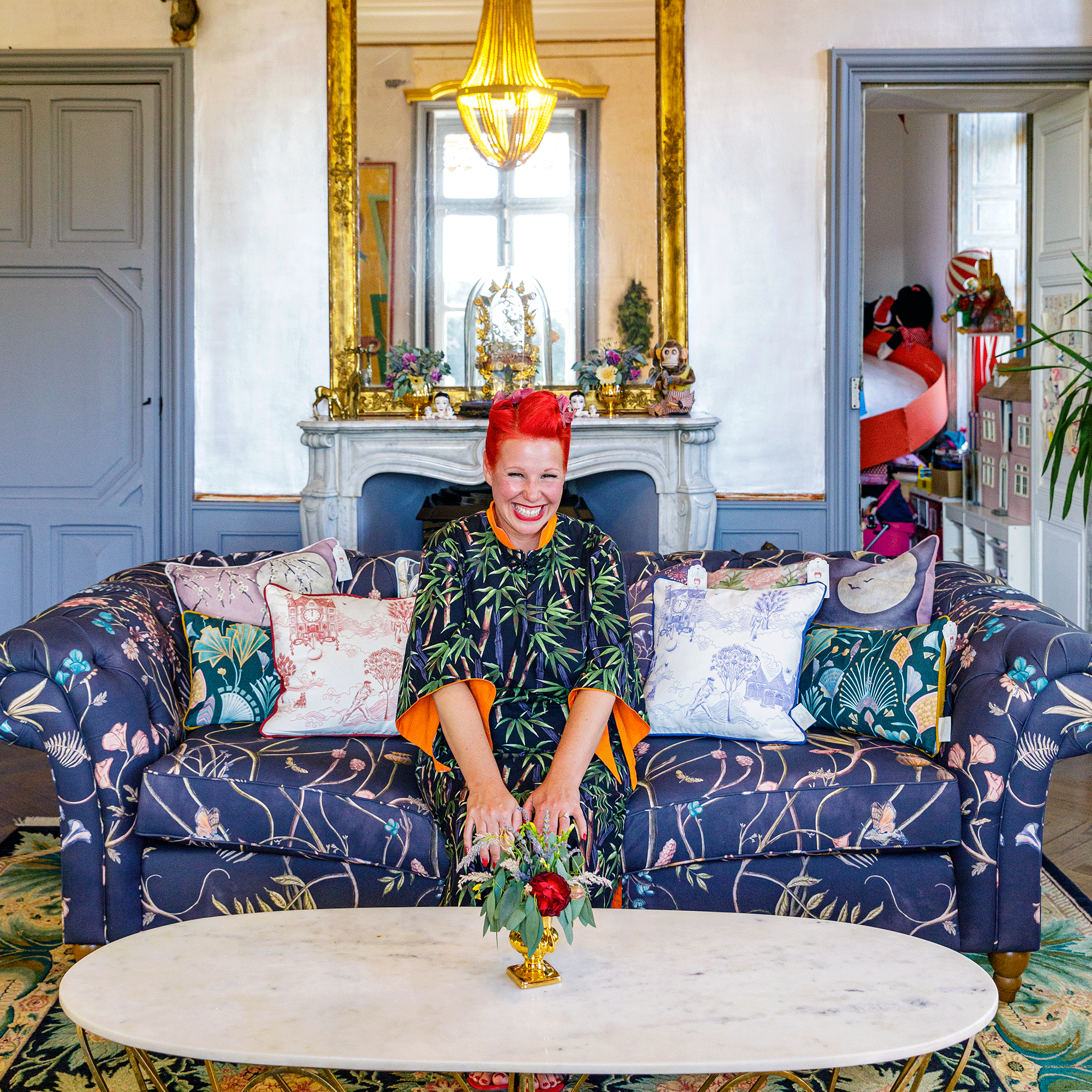 Angel Strawbridge on purple sofa