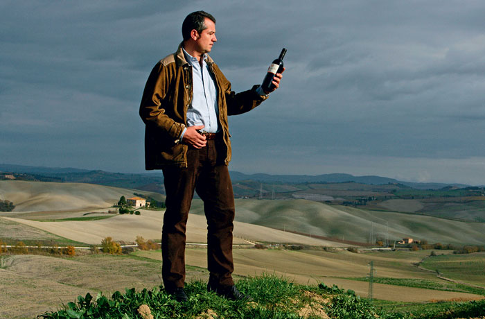 Giacomo Neri with a bottle of his Brunello