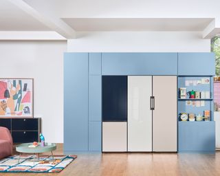 a samsung fridge freezer in a bright colorful kitchen with pink accents and blue cabinetry - samsung