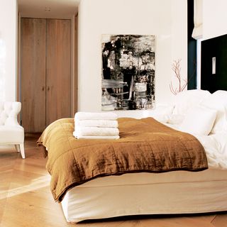 bedroom with wooden floor and white wall