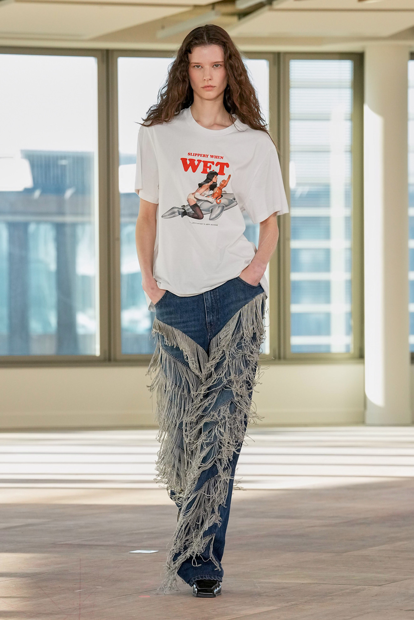 Model wears embellished jeans on the Stella McCartney runway.
