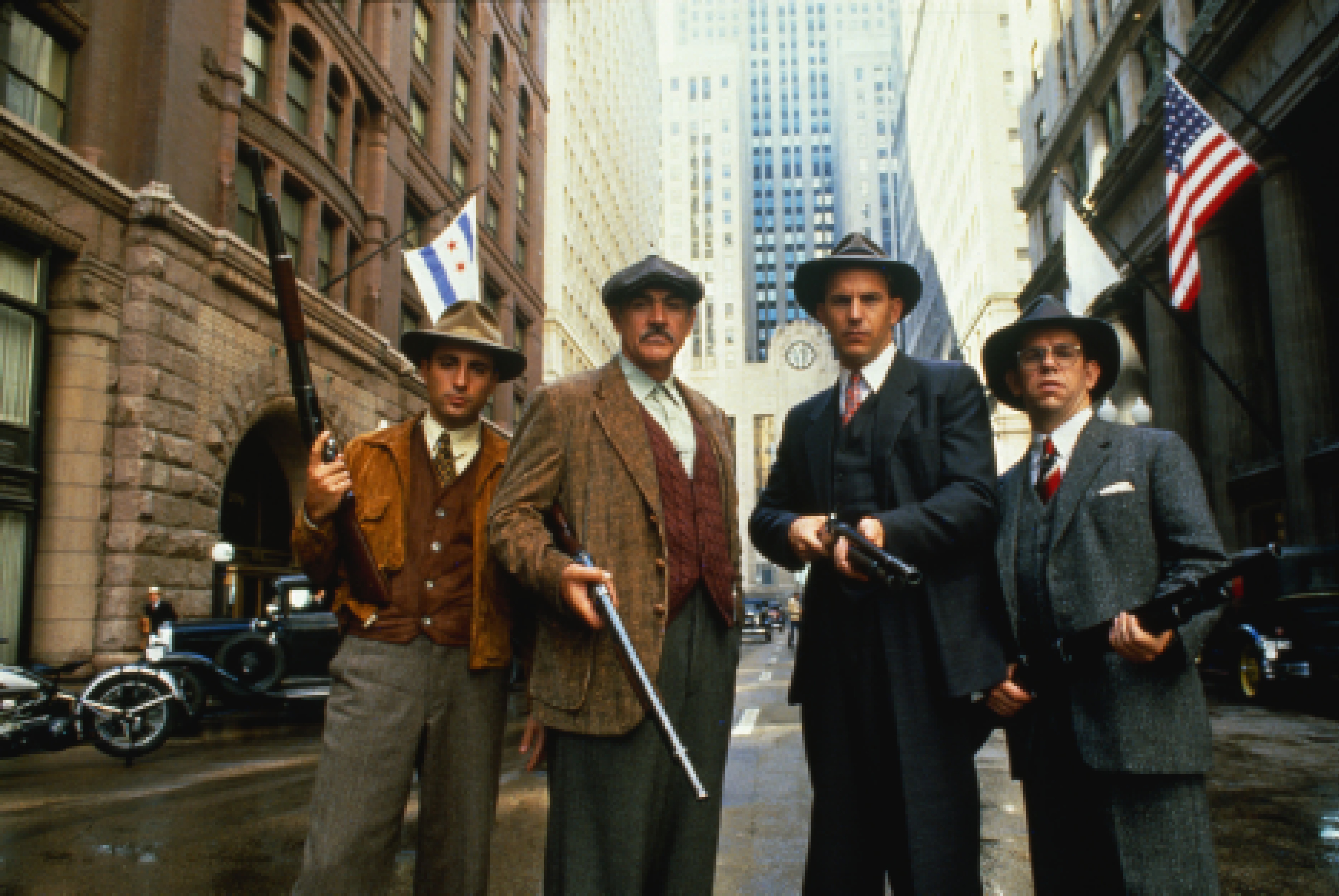The cast of The Untouchables standing in the street holding weapons
