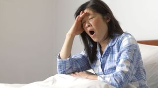 person with insomnia, struggling to sleep