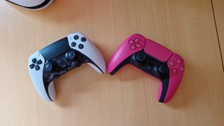 DualSense Edge review image showing the controller next to the original DualSense in Nova Pink