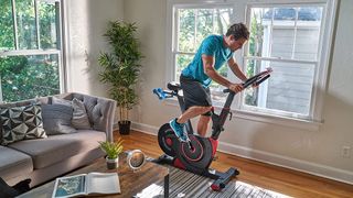 Image shows the Echelon Connect EX3 bike being used in a living room